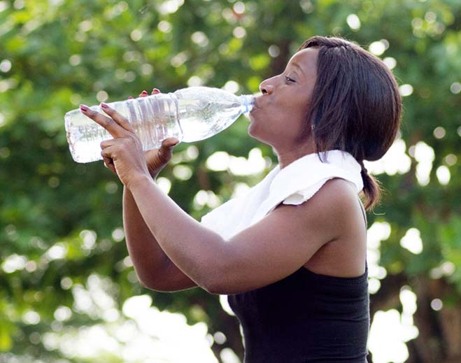 lady drinking big bottle of water